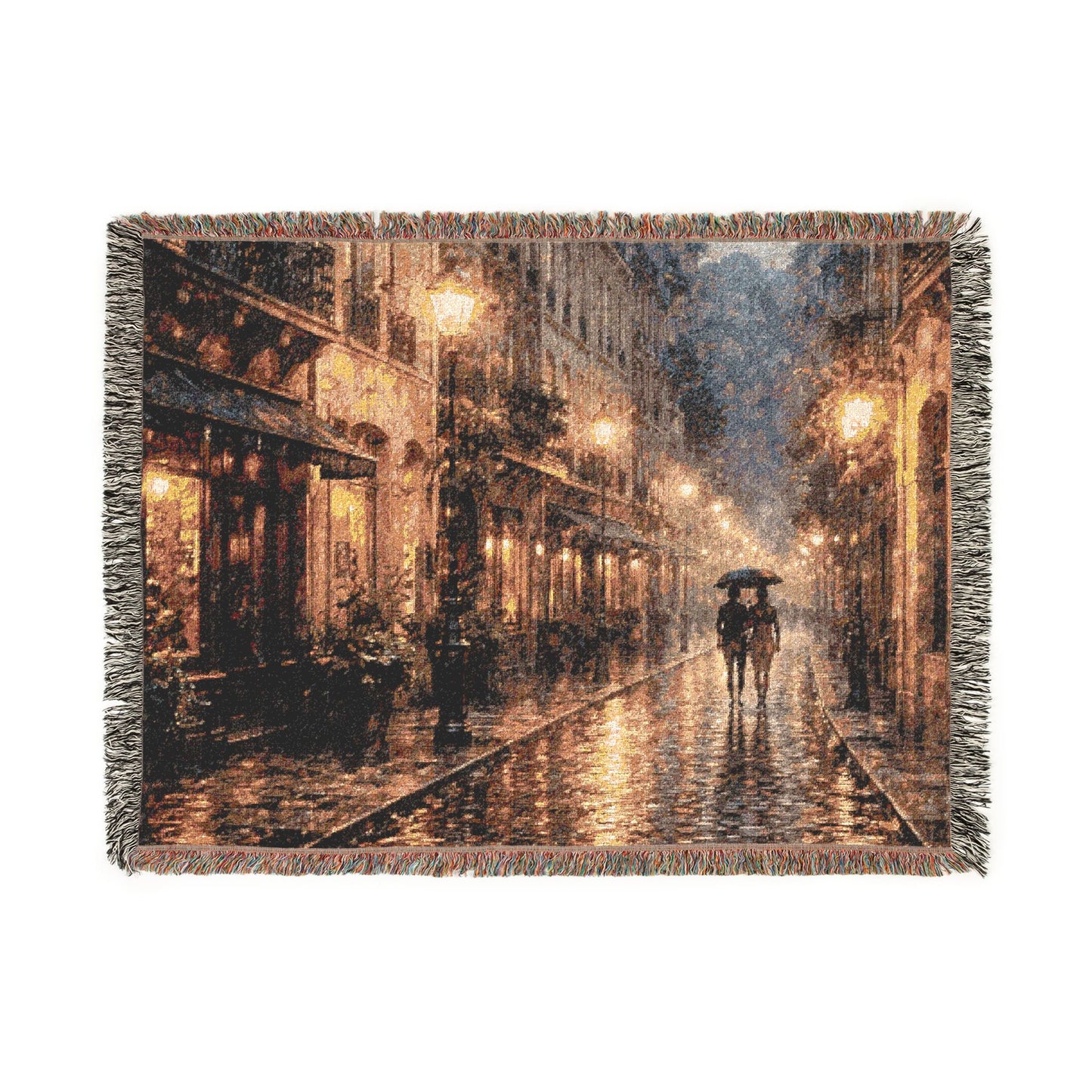 Woven blanket with a scene of two people walking under an umbrella on a rain-soaked street.