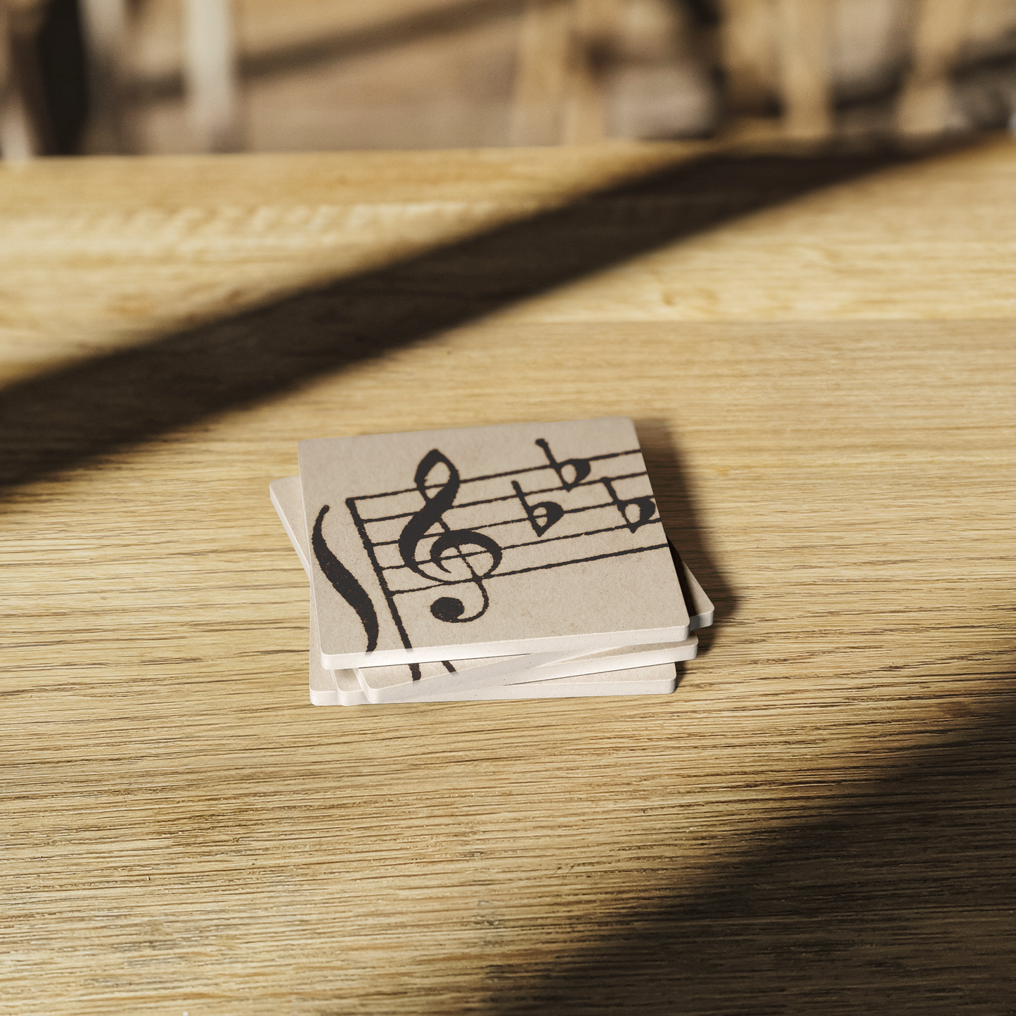 Eb_Major_Treble_Clef_Stone_Coaster_-_Set_SquareStoneCoaster_WoodTable_AS_Mockup.png